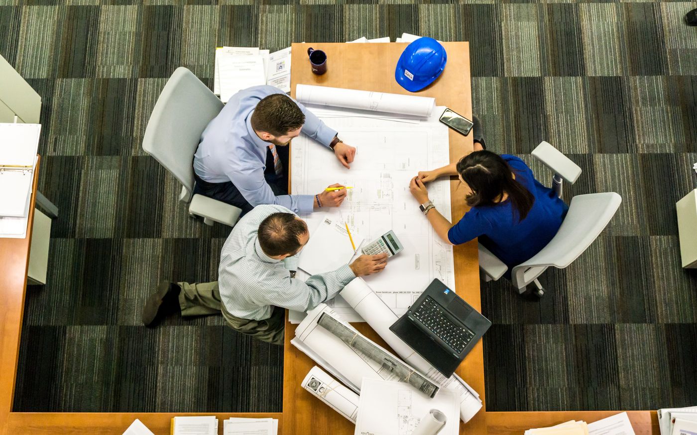 Professionals reviewing site plans for contractor and contract compliance workflows